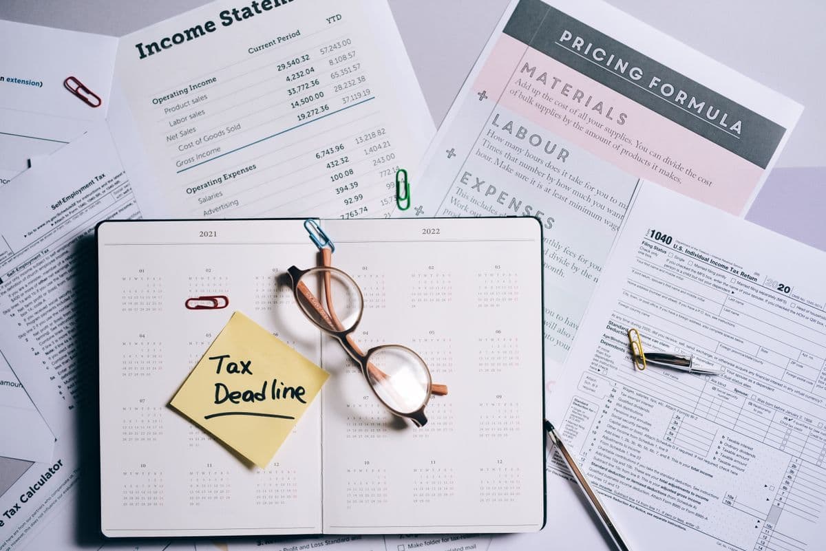 Tax planning documents and a calendar arranged on a desk.